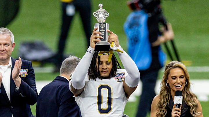 Jan 2, 2025; New Orleans, LA, USA;  Notre Dame Fighting Irish safety Xavier Watts (0) holds up the Sugar Bowl outstanding defensive player trophy after the game against the Georgia Bulldogs at Caesars Superdome. Mandatory Credit: Stephen Lew-Imagn Images