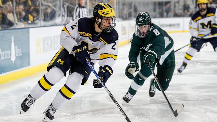 Michigan left wing Rutger McGroarty looks to pass against Michigan State defenseman Maxim Strbak during the third period at Yost Ice Arena in Ann Arbor on Friday, Feb. 9, 2024.