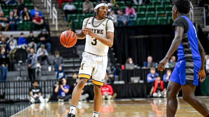 Wayne Memorial's Carlos Medlock Jr. moves the ball against Flint Carman-Ainsworth during the second quarter in the Division 1 state semifinal on Friday, March 14, 2025, at the Breslin Center in East Lansing.