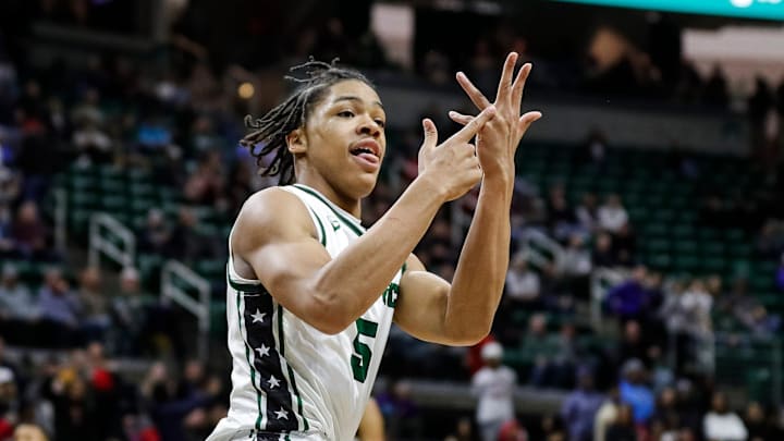 Cass Tech guard Darius Acuff (5) celebrates a play against Muskegon