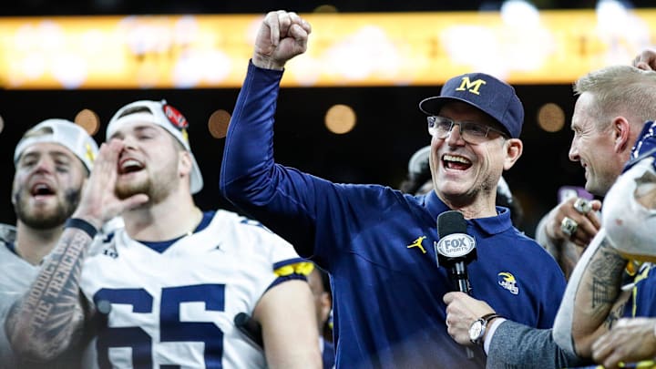 Former Michigan head coach Jim Harbaugh celebrates his national championship victory