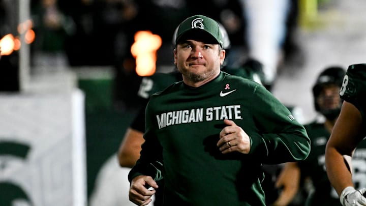 Michigan State's head coach Jonathan Smith runs onto the field with the team before the gam against Michigan Saturday, Oct. 25, 2025, at Spartan Stadium in East Lansing.