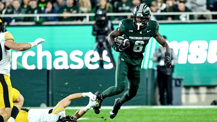 Michigan State's Nick Marsh, right, breaks a tackle attempt by Iowa's John Nestor during the third quarter on Saturday, Oct. 19, 2024, at Spartan Stadium in East Lansing.