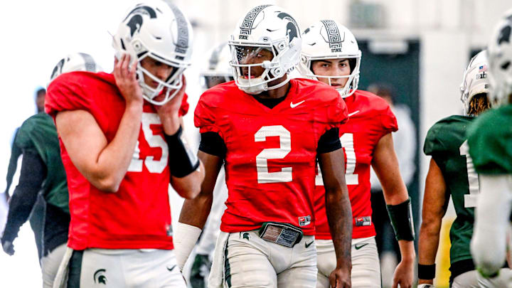 From left, Michigan State quarterbacks Leo Hannan, Aidan Chiles and Alessio Milivojevic look on during football practice on Tuesday, April 8, 2025, in East Lansing. From left, Michigan State quarterbacks Leo Hannan, Aidan Chiles and Alessio Milivojevic look on during football practice on Tuesday, April 8, 2025, in East Lansing.