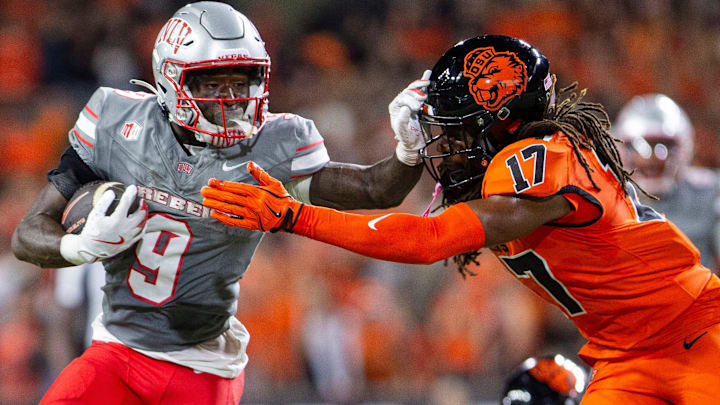UNLV Rebels running back Jai'Den Thomas (9) stiff arms Oregon State Beavers defensive back Skyler Thomas (17) during an NCAA football game against UNLV at Reser Stadium UNLV Rebels running back Jai'Den Thomas (9) stiff arms Oregon State Beavers defensive back Skyler Thomas (17) during an NCAA football game against UNLV at Reser Stadium