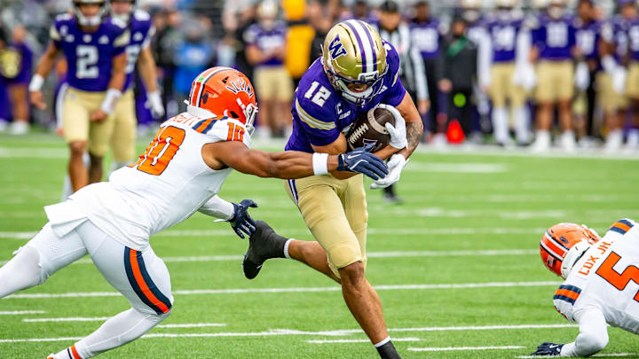 Denzel Boston runs past an Illinois tackler on one of his 10 receptions. 