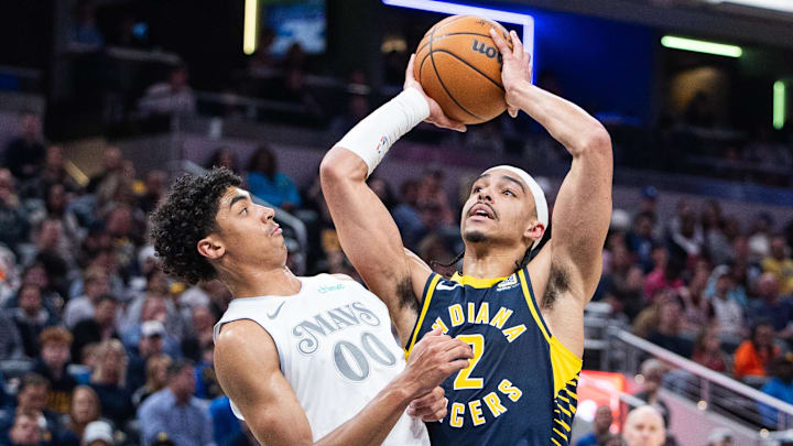 Indiana Pacers guard Andrew Nembhard shoots the ball while Dallas Mavericks guard Max Christie defends.