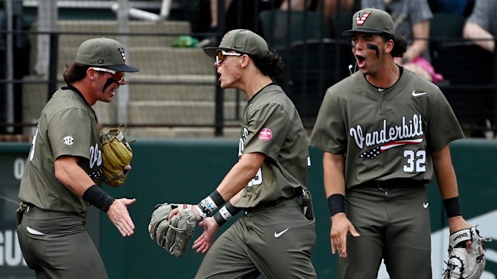 Vanderbilt left fielder Rustan Rigdon (19) celebrate with Brodie Johnston (9) and Riley Nelson (32) after throwing out Georgia's Slate Alford at third base during the eighth inning of an NCAA college baseball game at Hawkins Field Saturday, April 19, 2025, in Nashville, Tenn.
