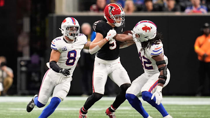 Oct 13, 2025; Atlanta, Georgia, USA;  Atlanta Falcons wide receiver Drake London (5) runs after the catch as Buffalo Bills linebackers Terrel Bernard (8) and Dorian Williams (42) defend during a game at Mercedes-Benz Stadium. 