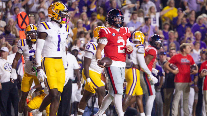 Oct 12, 2024; Baton Rouge, Louisiana, USA;  Mississippi Rebels quarterback Jaxson Dart (2) scrambles for a first down against LSU Tigers cornerback Ashton Stamps (1) during the first half at Tiger Stadium. Mandatory Credit: Stephen Lew-Imagn Images