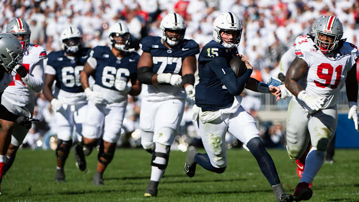 Penn State quarterback Drew Allar (15) keeps the ball in the first half of an NCAA football game against Ohio State at Beaver Stadium.