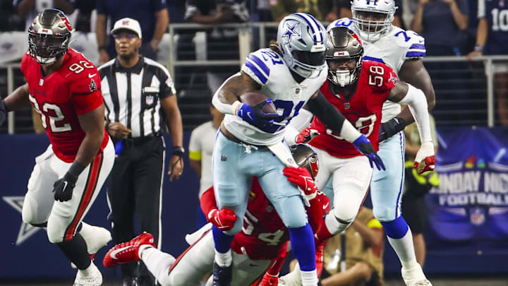 Sep 11, 2022; Arlington, Texas, USA; Dallas Cowboys running back Ezekiel Elliott (21) is tackled by
