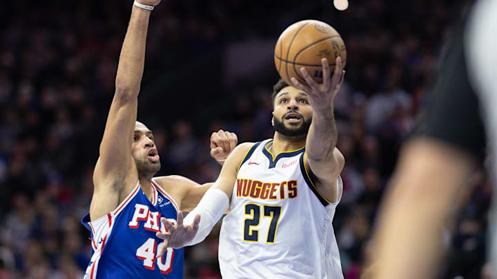 Jan 16, 2024; Philadelphia, Pennsylvania, USA; Denver Nuggets guard Jamal Murray (27) drives for a score past Philadelphia 76ers forward Nicolas Batum (40) during the second quarter at Wells Fargo Center. Mandatory Credit: Bill Streicher-Imagn Images