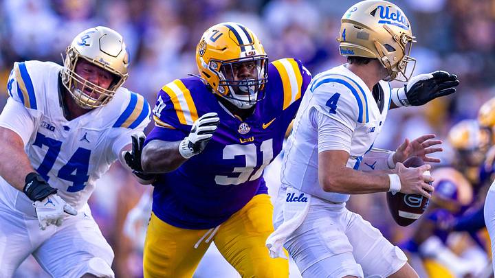 Sep 21, 2024; Baton Rouge, Louisiana, USA; LSU Tigers defensive tackle Jay'viar Suggs (31) evades UCLA Bruins offensive lineman Spencer Holstege (74) to sack quarterback Ethan Garbers (4) during the second half at Tiger Stadium. Mandatory Credit: Stephen Lew-Imagn Images Sep 21, 2024; Baton Rouge, Louisiana, USA; LSU Tigers defensive tackle Jay'viar Suggs (31) evades UCLA Bruins offensive lineman Spencer Holstege (74) to sack quarterback Ethan Garbers (4) during the second half at Tiger Stadium. Mandatory Credit: Stephen Lew-Imagn Images