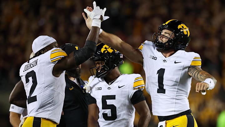 Sep 21, 2024; Minneapolis, Minnesota, USA; Iowa Hawkeyes quarterback Brendan Sullivan (1) celebrates his rushing touchdown with running back Kaleb Johnson (2) against the Minnesota Golden Gophers during the second half at Huntington Bank Stadium. Mandatory Credit: Matt Krohn-Imagn Images