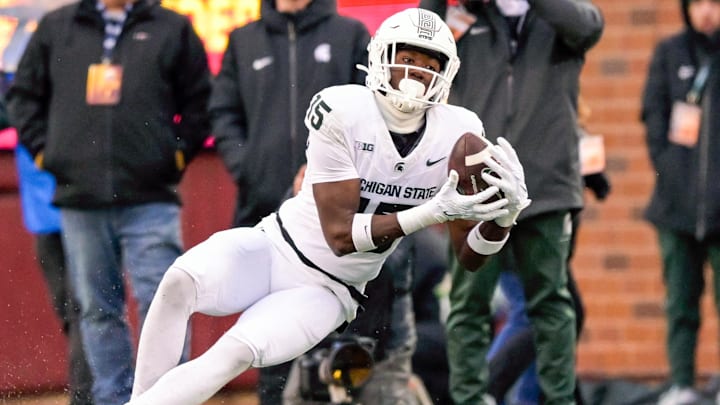 Oct 28, 2023; Minneapolis, Minnesota, USA;  Michigan State Spartans wide receiver Jaron Glover (15) catches a pass against the Minnesota Golden Gophers during the fourth quarter at Huntington Bank Stadium. Mandatory Credit: Nick Wosika-Imagn Images