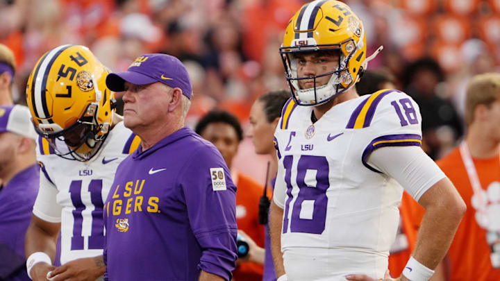 Aug 30, 2025; Clemson, South Carolina, USA; LSU Tigers head coach Brian Kelly and quarterback Garrett Nussmeier (18) look on during warmups before the game against the Clemson Tigers at Memorial Stadium. Mandatory Credit: Ken Ruinard-USA TODAY Network via Imagn Images Aug 30, 2025; Clemson, South Carolina, USA; LSU Tigers head coach Brian Kelly and quarterback Garrett Nussmeier (18) look on during warmups before the game against the Clemson Tigers at Memorial Stadium. Mandatory Credit: Ken Ruinard-USA TODAY Network via Imagn Images