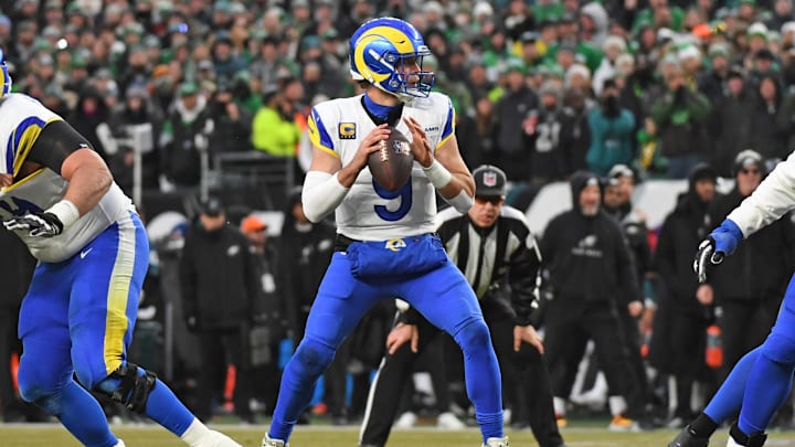 Jan 19, 2025; Philadelphia, Pennsylvania, USA; Los Angeles Rams quarterback Matthew Stafford (9) looks for a receiver against the Philadelphia Eagles in a 2025 NFC divisional round game at Lincoln Financial Field.  
