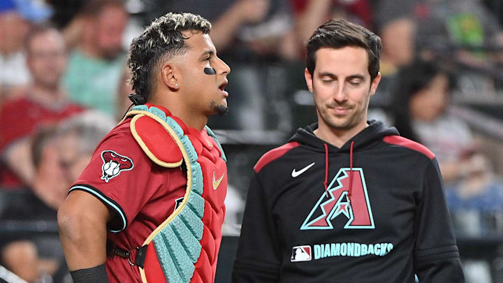 Apr 11, 2025; Phoenix, Arizona, USA; Arizona Diamondbacks catcher Gabriel Moreno (14) sees a trainer after being hit by a pitch in the fifth inning at Chase Field. Mandatory Credit: Matt Kartozian-Imagn Images