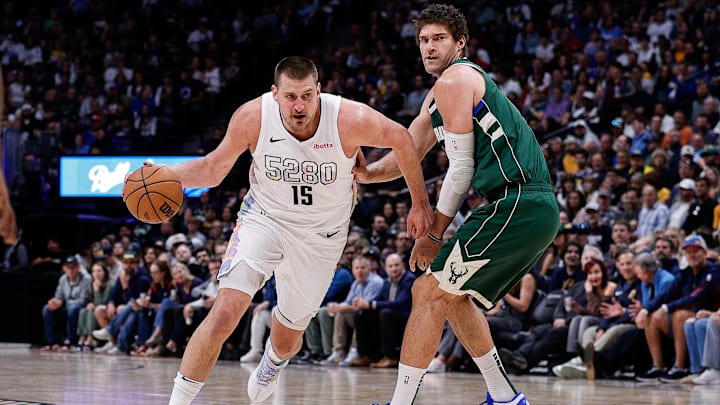 Mar 26, 2025; Denver, Colorado, USA; Denver Nuggets center Nikola Jokic (15) drives to the net against Milwaukee Bucks center Brook Lopez (11) in the first quarter at Ball Arena. Mandatory Credit: Isaiah J. Downing-Imagn Images Mar 26, 2025; Denver, Colorado, USA; Denver Nuggets center Nikola Jokic (15) drives to the net against Milwaukee Bucks center Brook Lopez (11) in the first quarter at Ball Arena. Mandatory Credit: Isaiah J. Downing-Imagn Images
