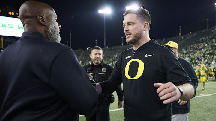 Nov 9, 2024; Eugene, Oregon, USA; Maryland Terrapins head coach Mike Locksley, left, congratulates Oregon Ducks head coach Dan Lanning after a game at Autzen Stadium. Mandatory Credit: Troy Wayrynen-Imagn Images
