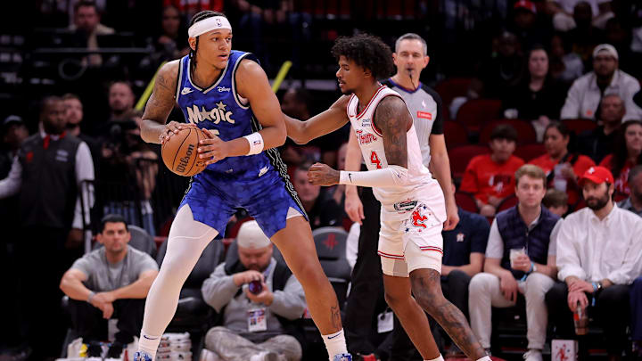 Orlando Magic forward Paolo Banchero (5) handles the ball against Houston Rockets guard Jalen Green (4) during the first quarter at Toyota Center.