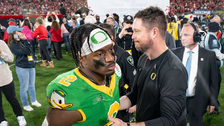 Oregon head coach Dan Lanning, right greets inside linebacker Jeffrey Bassa as the team walks off the field as the Oregon Ducks face the Ohio State Buckeyes Wednesday, Jan. 1, 2025, in the quarterfinal of the College Football Playoff at the Rose Bowl in Pasadena, Calif.