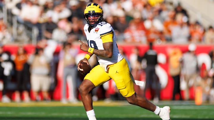 Dec 31, 2025; Orlando, FL, USA; Michigan Wolverines quarterback Bryce Underwood (19) looks to throw on the run against the Texas Longhorns during the first half at Camping World Stadium. Mandatory Credit: Matt Pendleton-Imagn Images