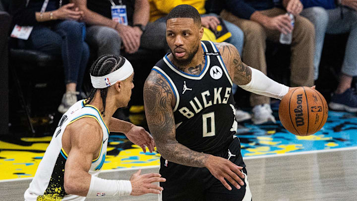 Apr 22, 2025; Indianapolis, Indiana, USA; Milwaukee Bucks guard Damian Lillard (0) dribbles  the ball while Indiana Pacers guard Andrew Nembhard (2) defends during game two of first round for the 2024 NBA Playoffs at Gainbridge Fieldhouse. Mandatory Credit: Trevor Ruszkowski-Imagn Images