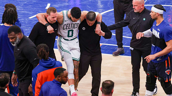 May 12, 2025; New York, New York, USA; Boston Celtics forward Jayson Tatum (0) is helped off the court