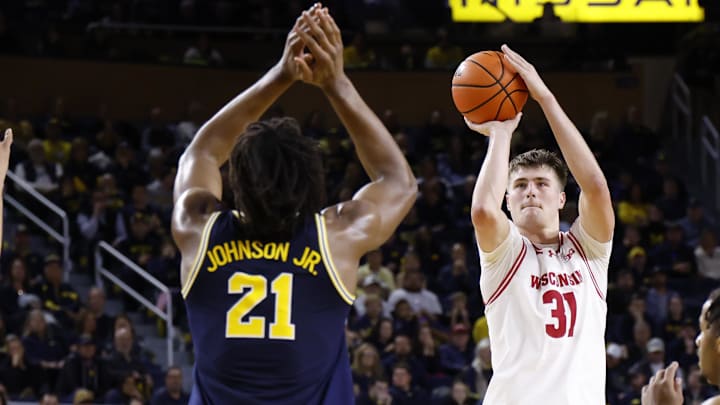 Jan 10, 2026; Ann Arbor, Michigan, USA; Wisconsin Badgers forward Nolan Winter (31) shoots on Michigan Wolverines forward Morez Johnson Jr. (21) in the second half at Crisler Center. Mandatory Credit: Rick Osentoski-Imagn Images Jan 10, 2026; Ann Arbor, Michigan, USA; Wisconsin Badgers forward Nolan Winter (31) shoots on Michigan Wolverines forward Morez Johnson Jr. (21) in the second half at Crisler Center. Mandatory Credit: Rick Osentoski-Imagn Images