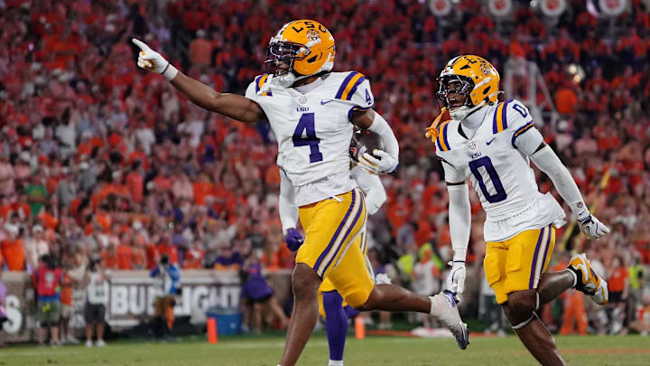 Aug 30, 2025; Clemson, South Carolina, USA; LSU Tigers cornerback Mansoor Delane (4) celebrates with safety Tamarcus Cooley (0) after a play against the Clemson Tigers during the second half at Memorial Stadium. Mandatory Credit: Ken Ruinard-USA TODAY Network via Imagn Images