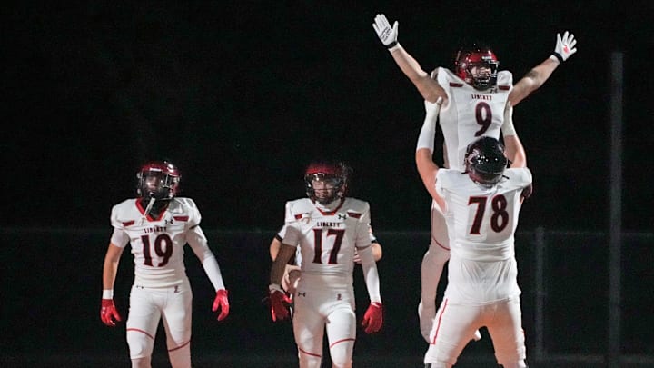 Liberty's Dominic Lombardo (9) celebrates a touchdown with teammate Nicholas Spence (78) during a game against Desert Edge at Desert Edge High School in Goodyear on Aug. 30, 2024. Lombardo and teammates had three more chances to celebrate on Saturday night en route to second straight Open Division title.