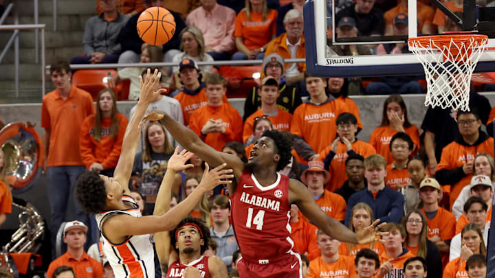 Feb 7, 2026; Auburn, Alabama, USA;  Alabama Crimson Tide center Charles Bediako (14) tries to block the shot of Auburn Tigers guard Keyshawn Hall (7) during the first half at Neville Arena. Mandatory Credit: John Reed-Imagn Images