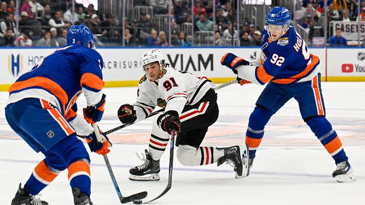 Oct 8, 2026; Elmont, New York, USA;  New York Islanders defenseman Adam Pelech (3) steals the puck from Chicago Blackhawks center Frank Nazar (91) defended by New York Islanders right wing Simon Holmstrom (92) during the first period at UBS Arena.  Mandatory Credit: Dennis Schneidler-Imagn Images
