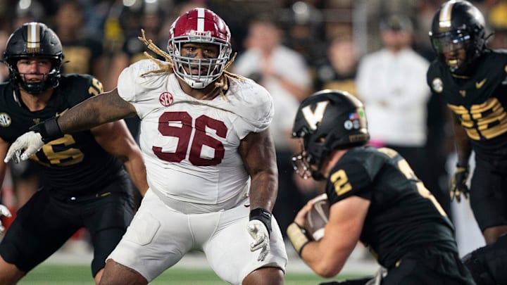 Alabama Crimson Tide defensive lineman Tim Keenan III (96) tries to corral Vanderbilt Commodores quarterback Diego Pavia (2) during their game at Vanderbilt Stadium in Nashville, Tenn., Saturday, Oct. 5, 2024.