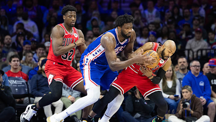 Jan 2, 2024; Philadelphia, Pennsylvania, USA; Chicago Bulls guard Jevon Carter (5) steals the ball from Philadelphia 76ers center Joel Embiid (21) during the third quarter at Wells Fargo Center. Mandatory Credit: Bill Streicher-Imagn Images