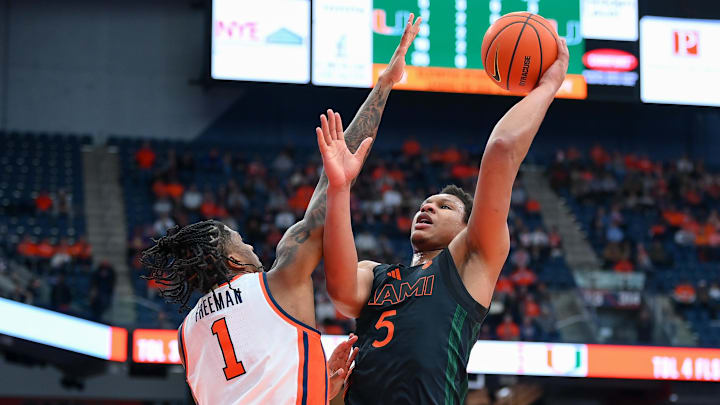 Jan 24, 2026; Syracuse, New York, USA; Miami Hurricanes forward Malik Reneau (5) shoots against Syracuse Orange forward Donnie Freeman (1) during the first half at the JMA Wireless Dome. Mandatory Credit: Rich Barnes-Imagn Images