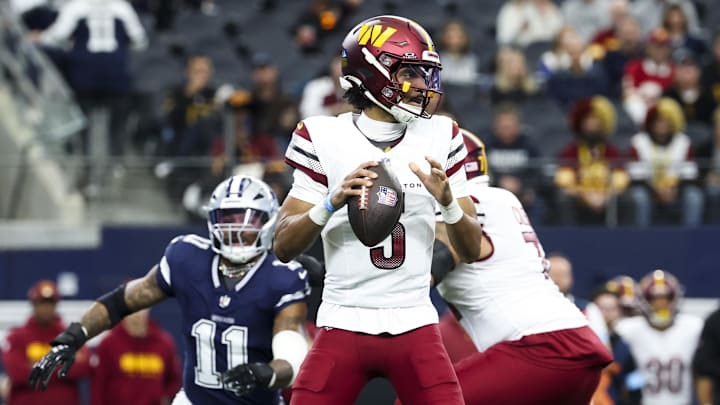 Jan 5, 2025; Arlington, Texas, USA;  Washington Commanders quarterback Jayden Daniels (5) throws as Dallas Cowboys linebacker Micah Parsons (11) chases during the first quarter at AT&T Stadium. Mandatory Credit: Kevin Jairaj-Imagn Images