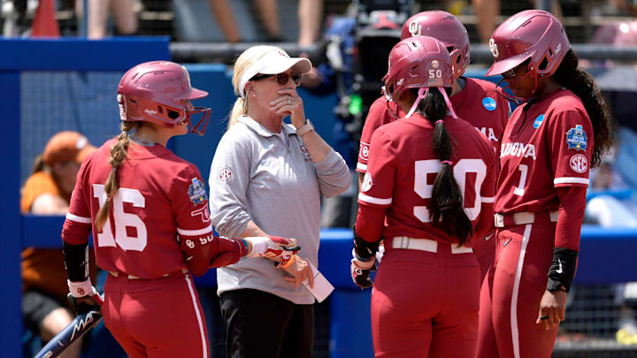 Oklahoma coach Patty Gasso talks with Oklahoma players during the WCWS.