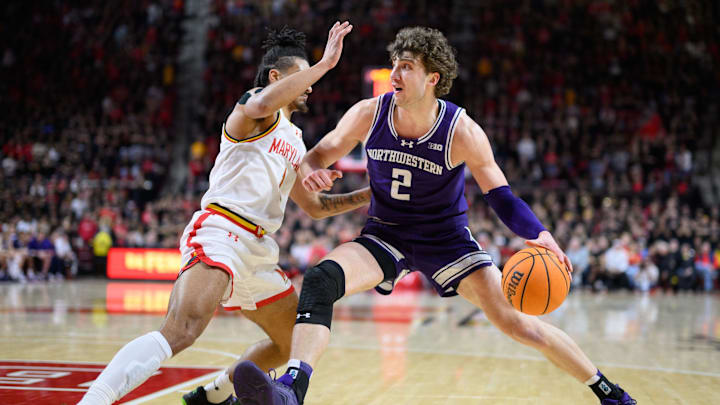 Mar 8, 2025; College Park, Maryland, USA; Northwestern Wildcats forward Nick Martinelli (2) handles the ball against Maryland Terrapins guard Rodney Rice (1) during the first half at Xfinity Center. Mandatory Credit: Reggie Hildred-Imagn Images