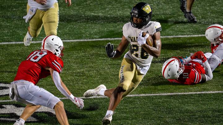 Warren Central High School senior Keyon Thomas (26) fends off the defense of Center Grove High School senior Jackson Burnett (18) during the second half of an IHSAA varsity football game, Friday, Aug. 21, 2026, at Center Grove High School. Warren Central High School senior Keyon Thomas (26) fends off the defense of Center Grove High School senior Jackson Burnett (18) during the second half of an IHSAA varsity football game, Friday, Aug. 21, 2026, at Center Grove High School.