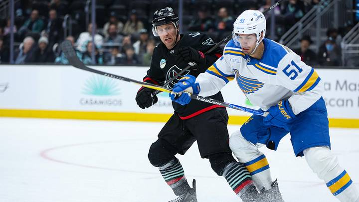 Mar 4, 2026; Seattle, Washington, USA;  Seattle Kraken left wing Jaden Schwartz (17) and St. Louis Blues defenseman Matthew Kessel (51) battle for the puck in the second period at Climate Pledge Arena. Mandatory Credit: Kevin Ng-Imagn Images