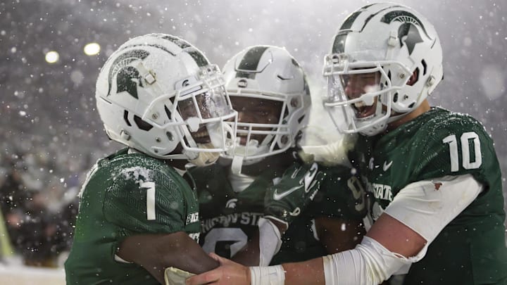 Nov 27, 2021; East Lansing, Michigan, USA; Michigan State Spartans wide receiver Jayden Reed (1) celebrates with running back Kenneth Walker III (9) and quarterback Payton Thorne (10) after making a touchdown catch during the fourth quarter against the Penn State Nittany Lions at Spartan Stadium. Mandatory Credit: Raj Mehta-Imagn Images Nov 27, 2021; East Lansing, Michigan, USA; Michigan State Spartans wide receiver Jayden Reed (1) celebrates with running back Kenneth Walker III (9) and quarterback Payton Thorne (10) after making a touchdown catch during the fourth quarter against the Penn State Nittany Lions at Spartan Stadium. Mandatory Credit: Raj Mehta-Imagn Images