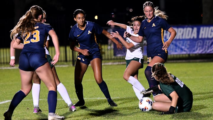 St. Thomas Aquinas and Lakewood Ranch players scramble for a loose ball in front of the net before the ball is eventually gobbled up by the Lakewood goalkeeper. STA won the Class 6A state semifinal, 2-0, at Lake Myrtle Sports Complex on Thursday. St. Thomas Aquinas and Lakewood Ranch players scramble for a loose ball in front of the net before the ball is eventually gobbled up by the Lakewood goalkeeper. STA won the Class 6A state semifinal, 2-0, at Lake Myrtle Sports Complex on Thursday.