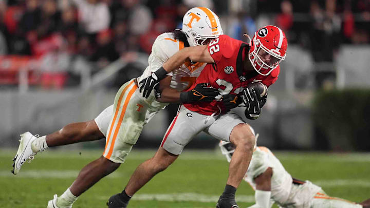 Georgia running back Cash Jones (32) is tackled by Tennessee linebacker Arion Carter (7) during a college football game between Tennessee and Georgia at Sanford Stadium in Athens, Ga., on Saturday, November 16, 2024.