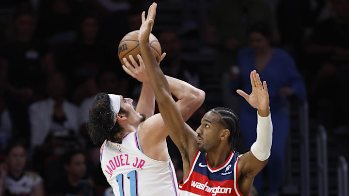 Apr 13, 2025; Miami, Florida, USA;  Washington Wizards forward Alex Sarr (20) defends Miami Heat guard Jaime Jaquez Jr. (11) during the second half at Kaseya Center. Mandatory Credit: Rhona Wise-Imagn Images