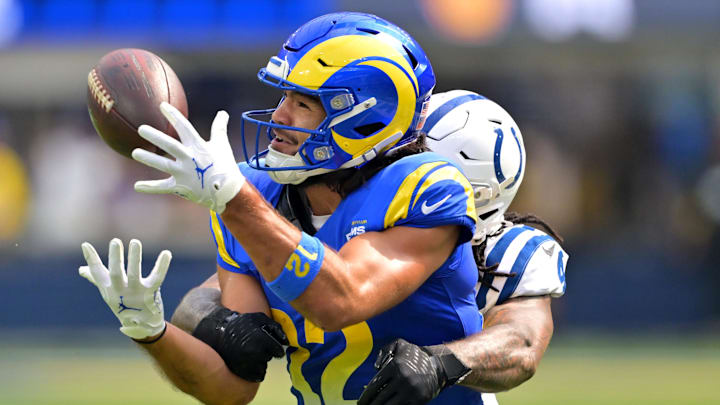Sep 28, 2025; Inglewood, California, USA; Los Angeles Rams wide receiver Puka Nacua (12) is stopped by Indianapolis Colts cornerback Xavien Howard (4) after a 31 yard pass reception in the first half at SoFi Stadium. 