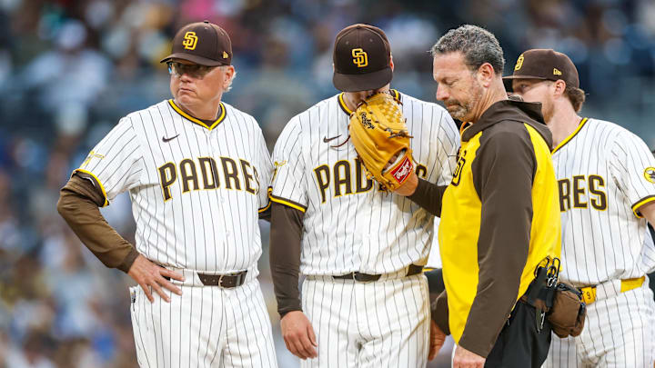Jun 24, 2025; San Diego, California, USA; San Diego Padres starting pitcher Ryan Bergert (38) speaks with Padres medical staff after being hit by a line drive during the fourth inning against the Washington Nationals at Petco Park. Mandatory Credit: David Frerker-Imagn Images