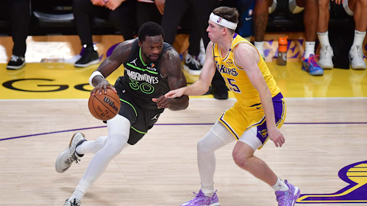 Apr 30, 2025; Los Angeles, California, USA: Minnesota Timberwolves forward Julius Randle (30) moves the ball against Los Angeles Lakers guard Austin Reaves (15) during the second half in game five of first round for the 2025 NBA Playoffs at Crypto.com Arena. Mandatory Credit: Gary A. Vasquez-Imagn Images